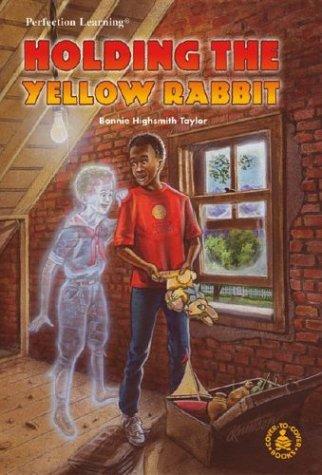 Holding the yellow rabbit book cover